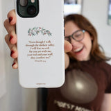 A person holding a white iPhone case with Psalm 23:4 verse and floral design, symbolizing peace and protection.