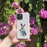 iPhone case with an artistic portrayal of Jesus carrying the cross, set against a background of vibrant purple flowers.