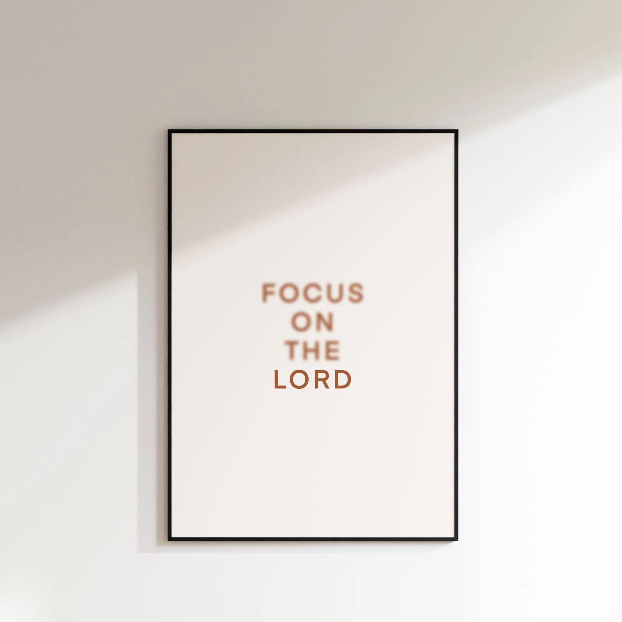 “Focus on the Lord” printable Christian wall art, minimalist text print on white wall.
