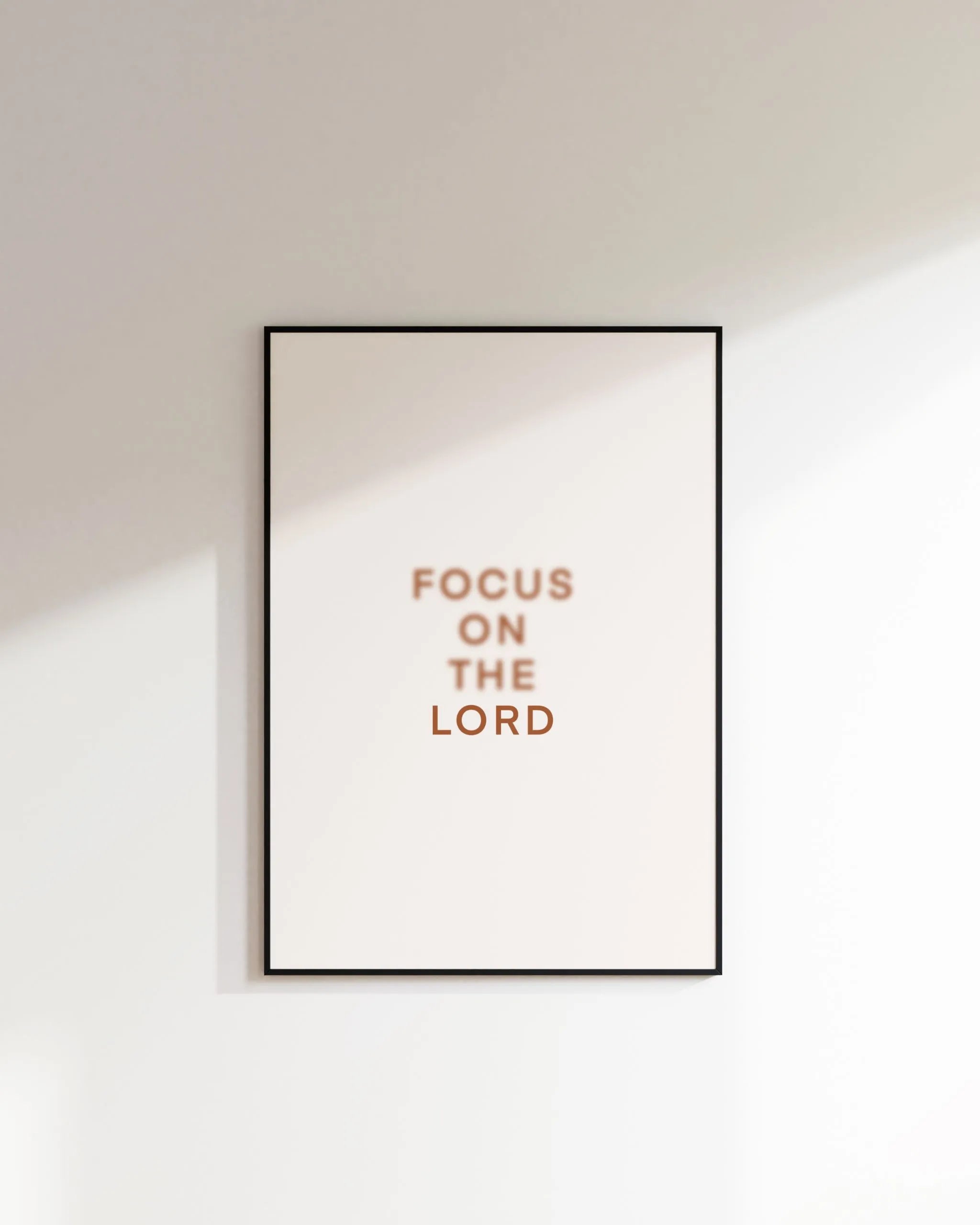 “Focus on the Lord” printable Christian wall art, minimalist text print on white wall.