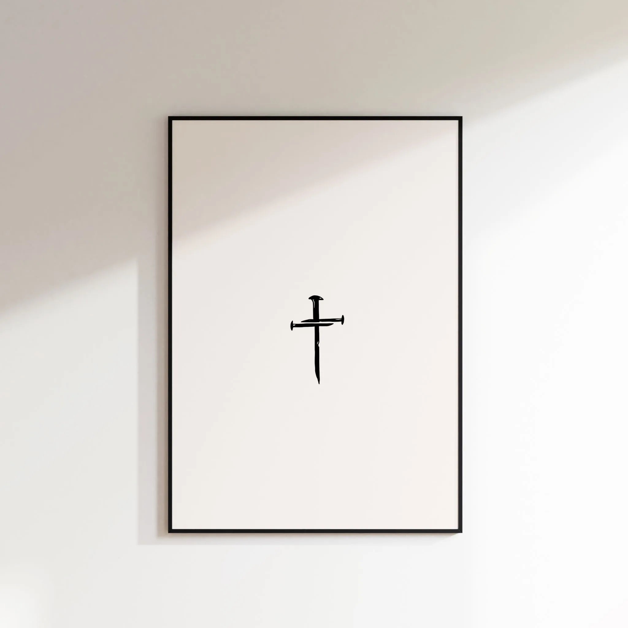 Nail Cross minimalist Christian wall art in black frame on white wall, printable download.