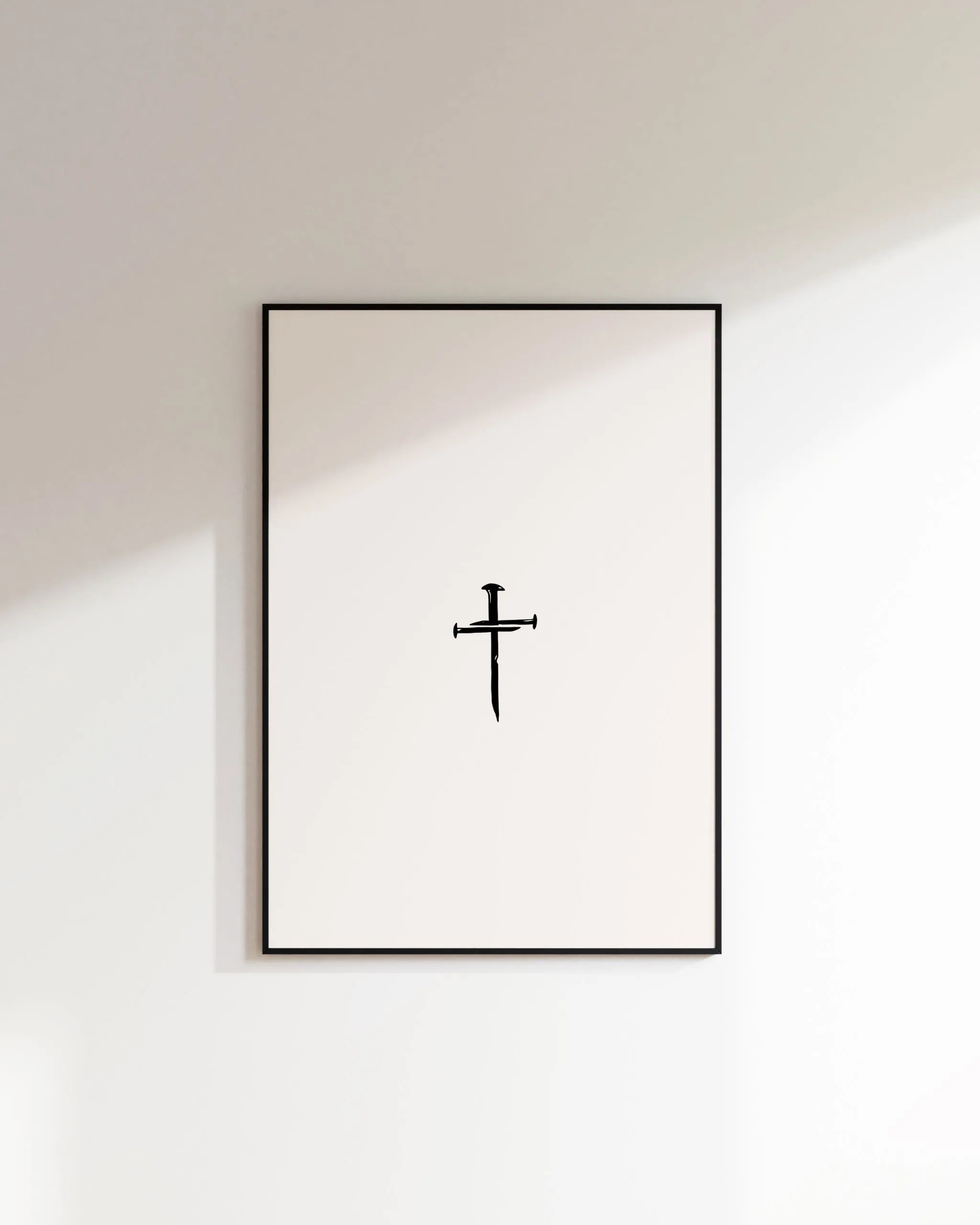 Nail Cross minimalist Christian wall art in black frame on white wall, printable download.