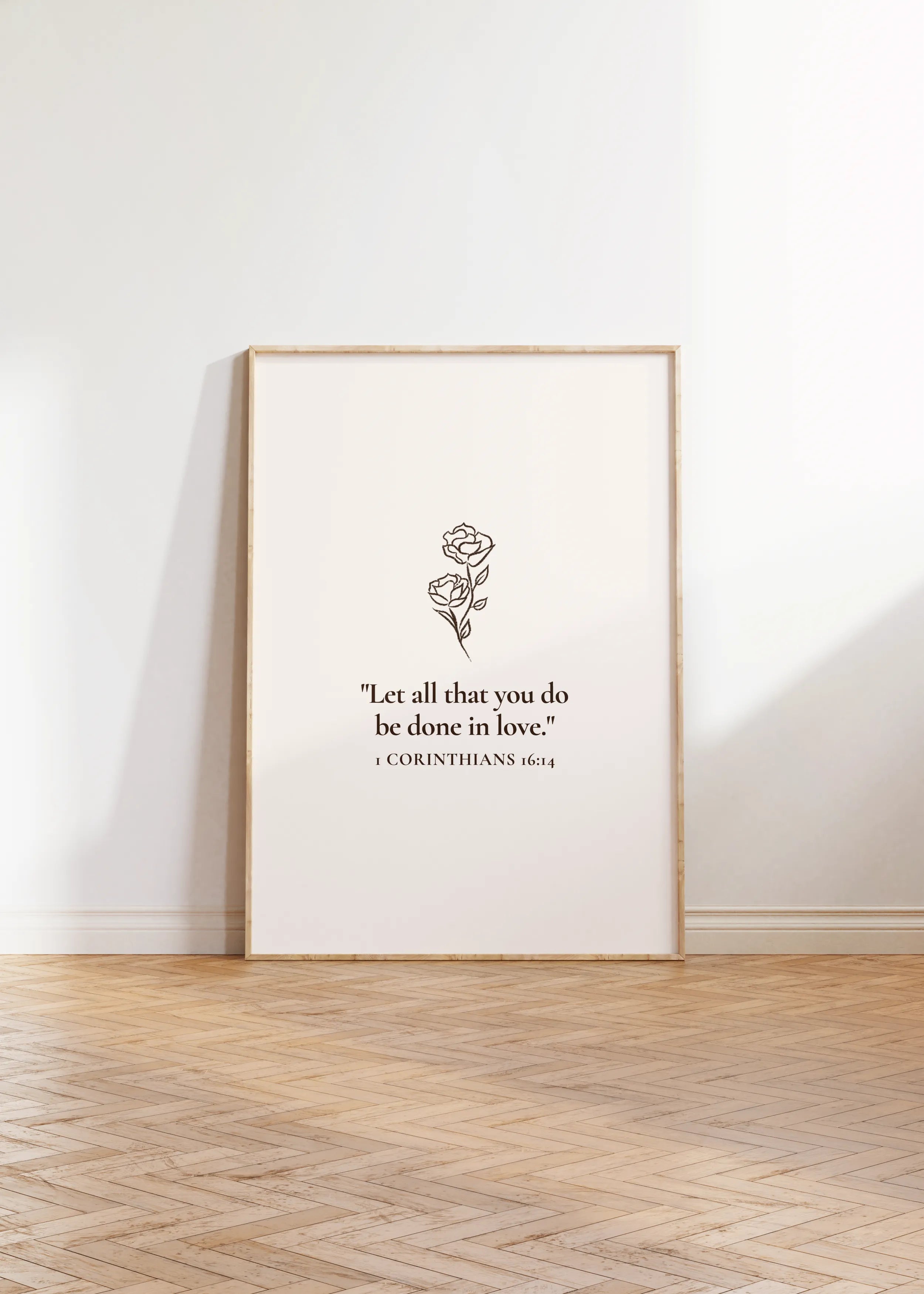 Christian wall art “All Things in Love” framed print leaning on floor.