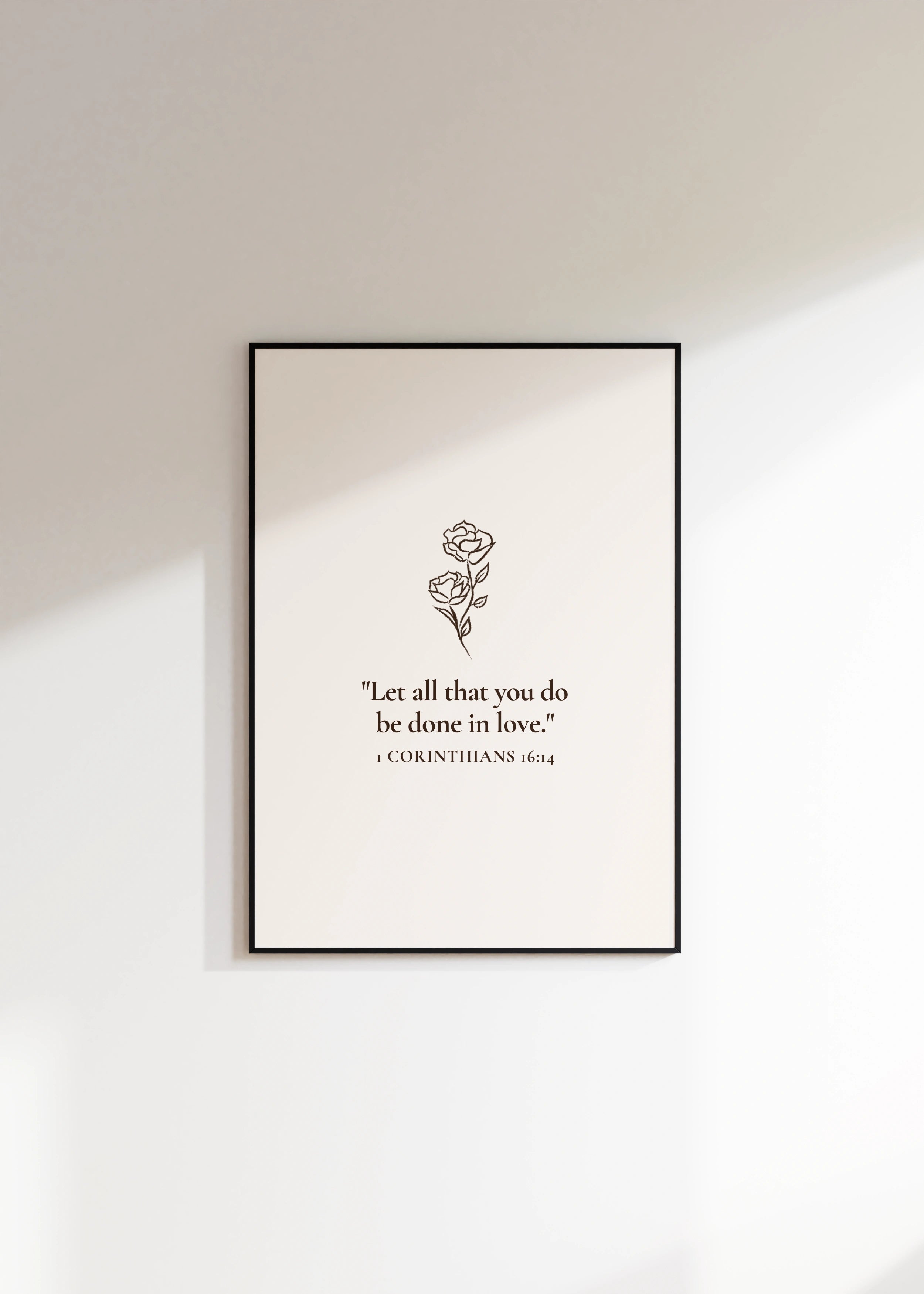 “All Things in Love” Christian print on white wall.