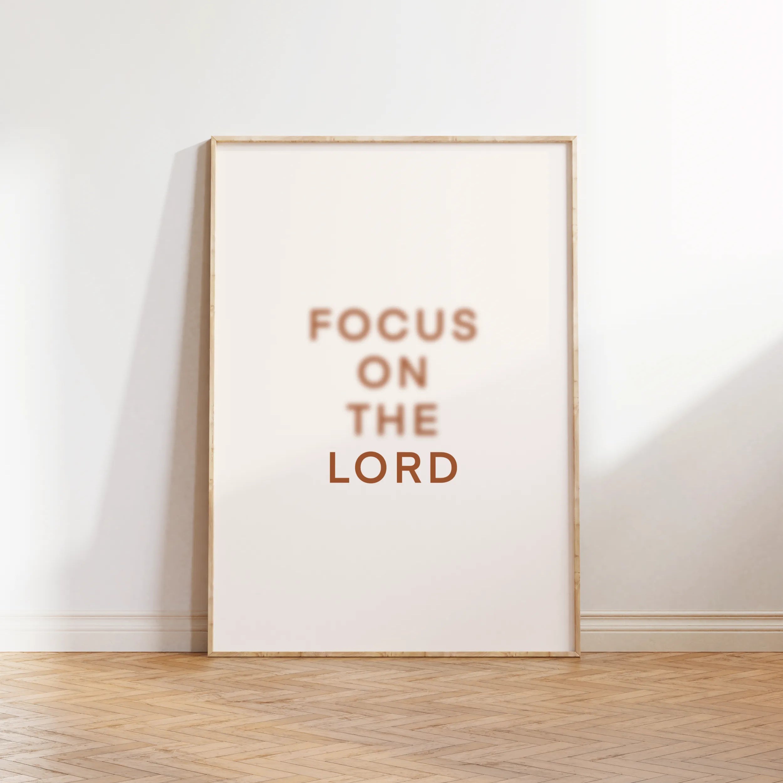 “Focus on the Lord” Christian wall art framed and leaning on floor.

