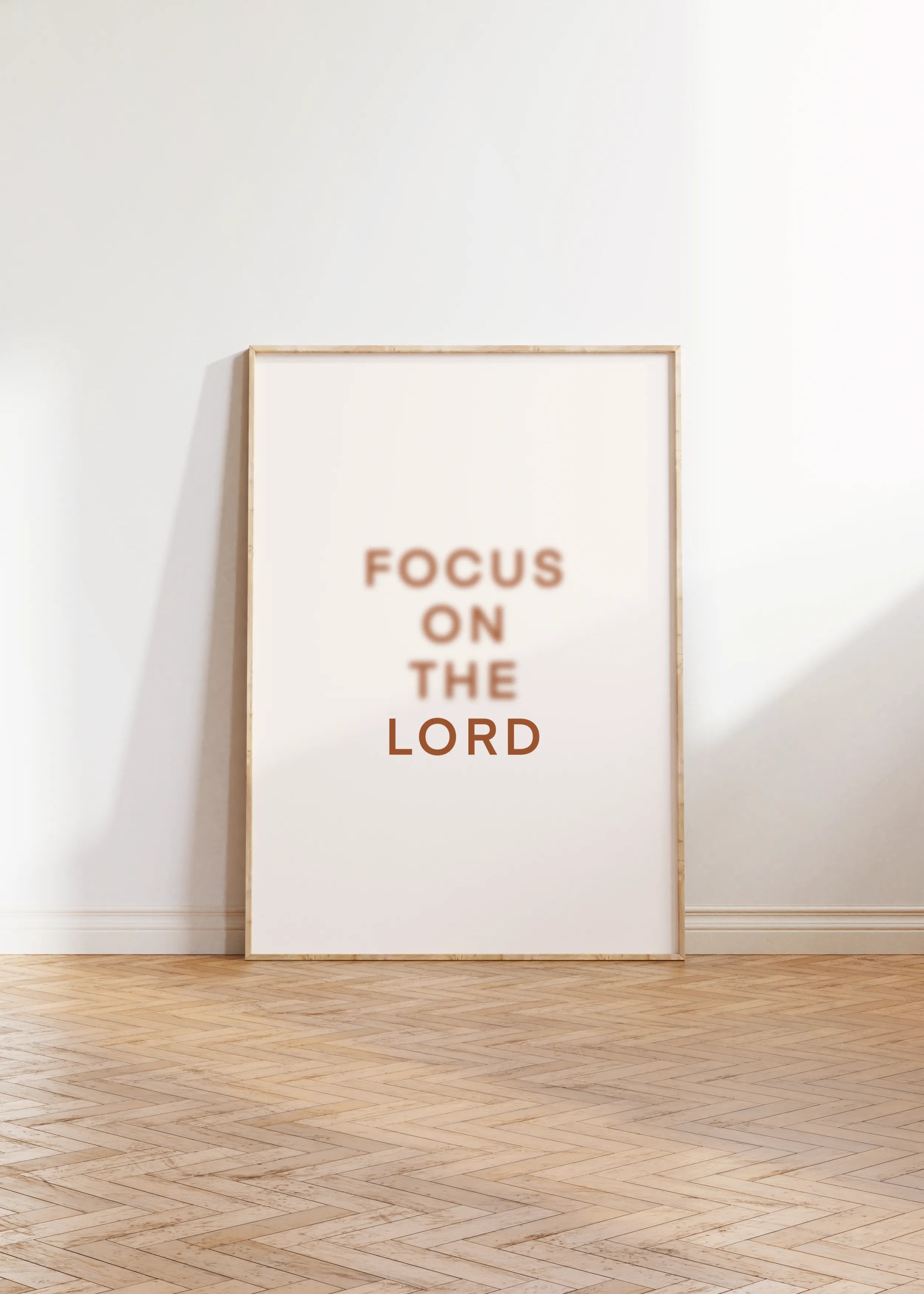 “Focus on the Lord” Christian wall art framed and leaning on floor.
