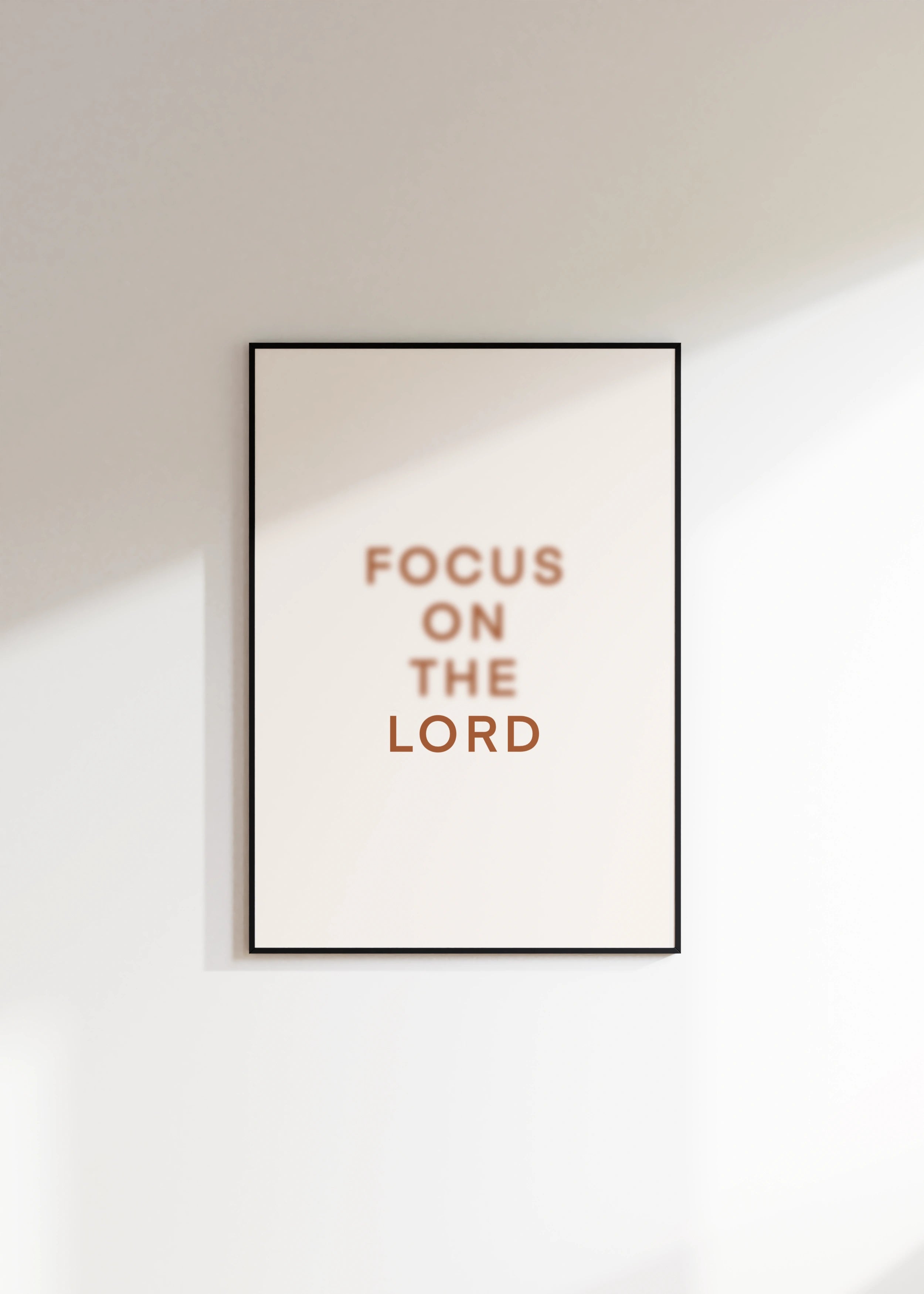 “Focus on the Lord” Christian print centered on wall.