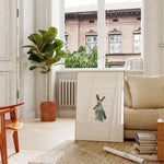 “Weight of Mercy” Christian wall art on console by window.
